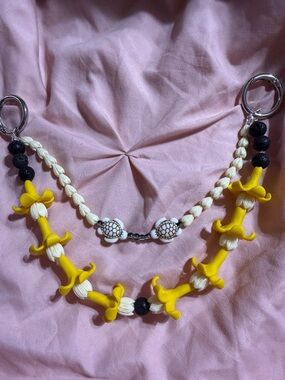 Double strand purse lei with handmade Pikake and Puakenikeni flowers.